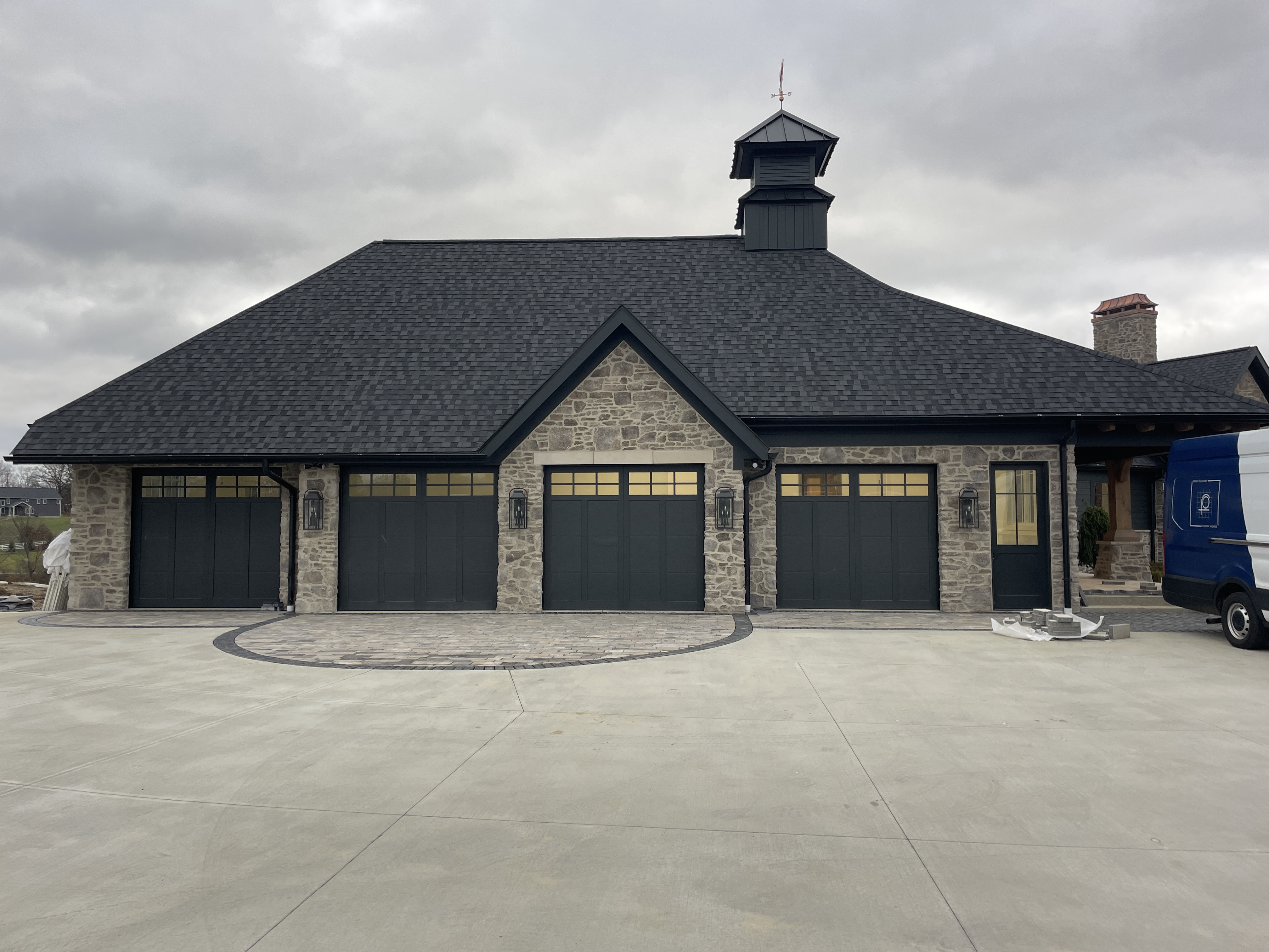 Fred Olivieri Custom Homes Cottage Home in Stark County Ohio Stone exterior Garage Custom Garage Doors