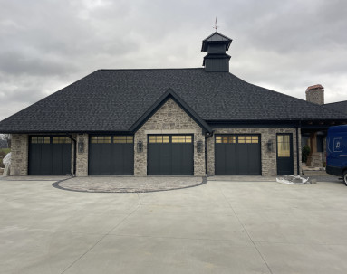 Fred Olivieri Custom Homes Cottage Home in Stark County Ohio Stone exterior Garage Custom Garage Doors
