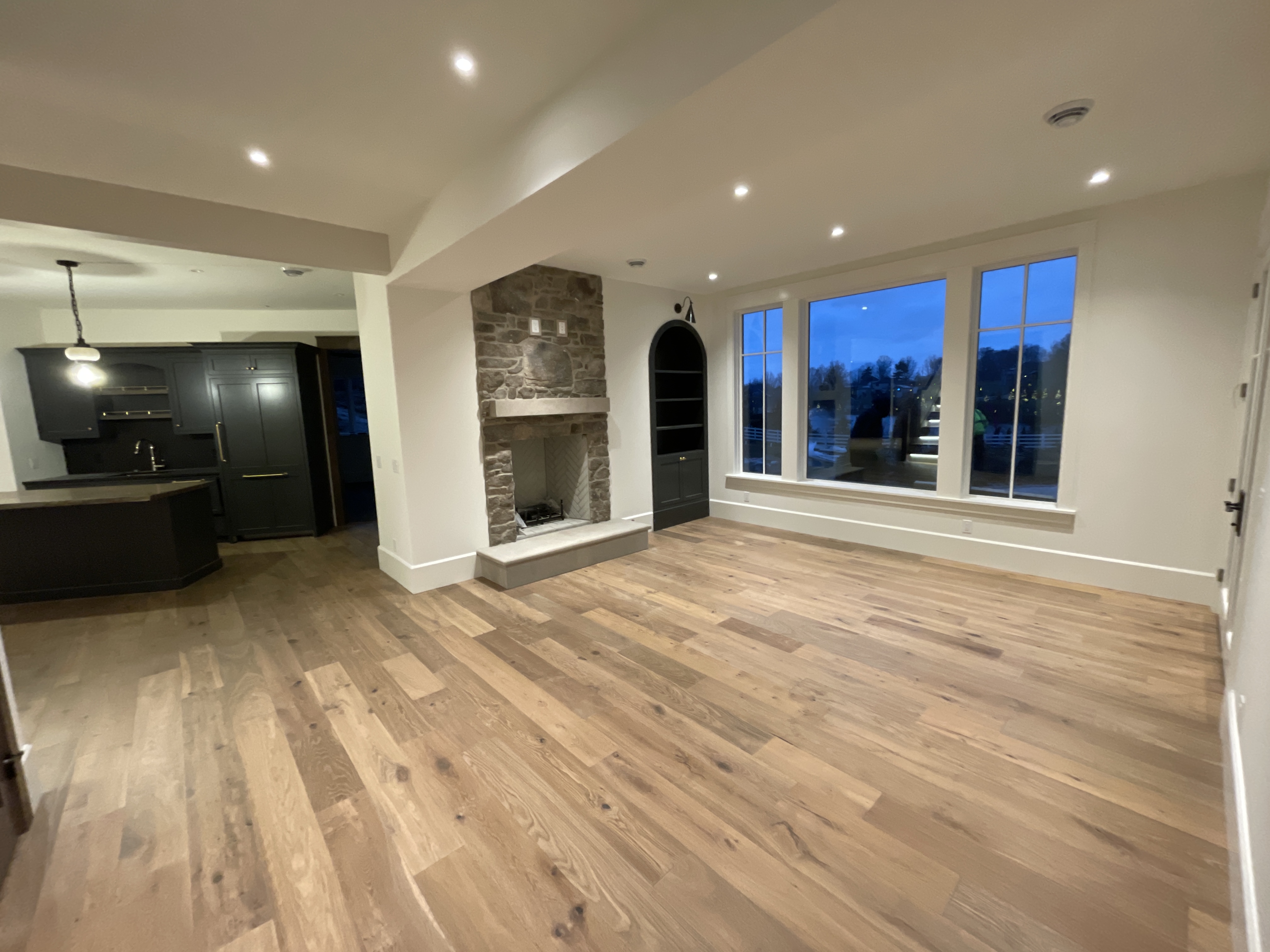 Fred Olivieri Custom Homes Home Builder in North East Ohio in Stark County Basement Living Room Stone Fireplace with Wood Flooring